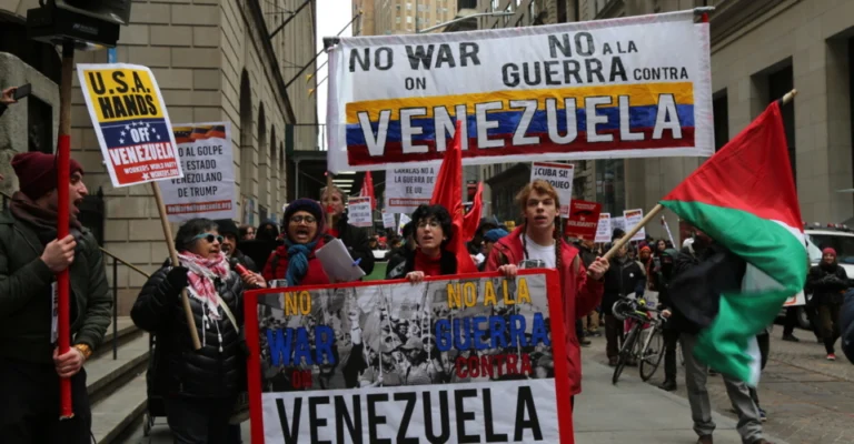 US opposition to Venezuela invasion shown in anti-war protests with peace symbols and flags
