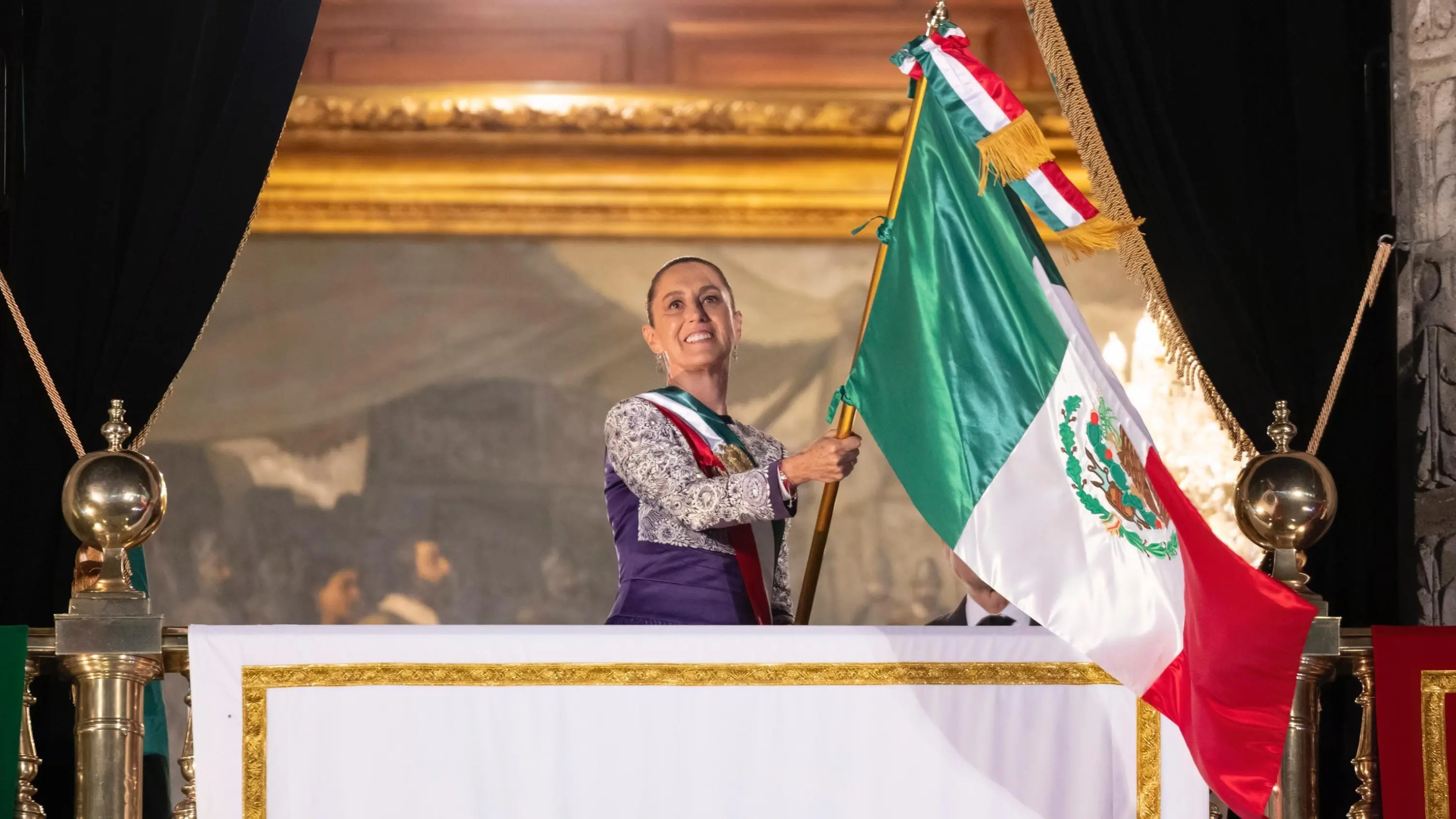 President Claudia Sheinbaum waving the Mexican flag before Zocalo. Photo: X/ @Claudiashein