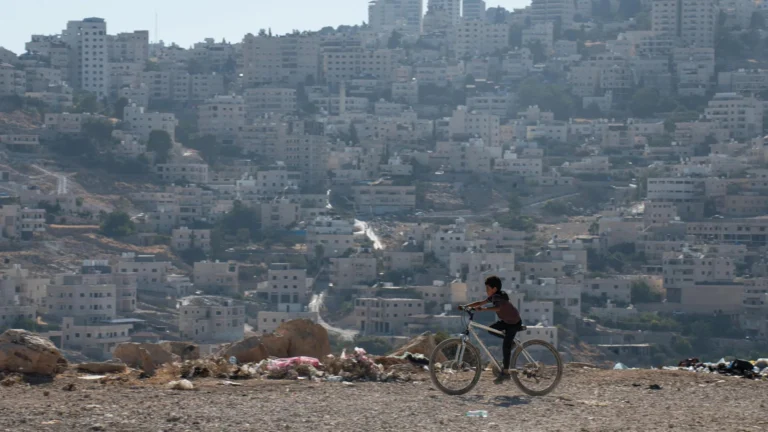 (FILE) A boy pedals his bicycle in the Al Eizariya area. Photo: EFE.