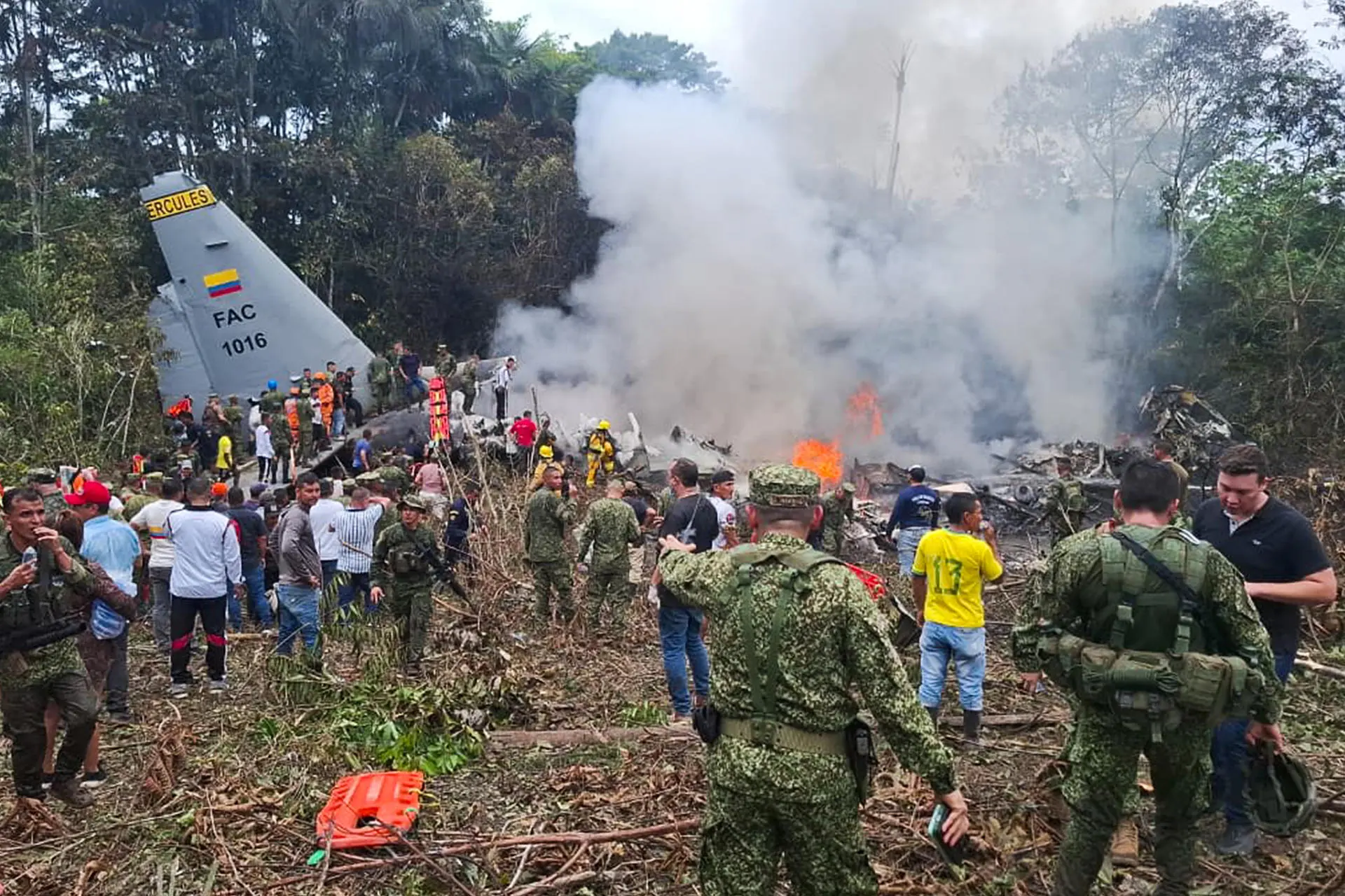 Rescue teams work at the crash site in Putumayo following a military aircraft accident.