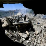 People walk amongst the rubble of a building targeted in an Israeli airstrike in Sir el-Gharbiyeh, south Lebanon, 08 March 2026 leaving at least 17 people killed and 7 others injured. The Israeli military stated it is conducting strikes across the country targeting Hezbollah infrastructure and personnel. According to the Lebanese Ministry of Public Health, at least 394 people were killed and 1160 others injured in airstrikes across Beirut's southern suburbs and villages in southern Lebanon. Photo: EFE.