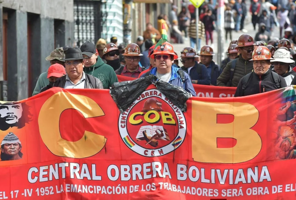 Bolivia road blockades COB protests La Paz Oruro highway unions Mario Argollo arrest warrants Rodrigo Paz government crisis