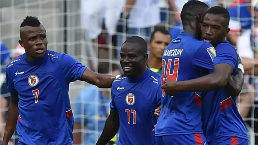 Haiti revises World Cup kit, sparking debate over historical symbolism. Discover the impact of the Battle of Vertieres on Les Grenadiers' return to the tournament.