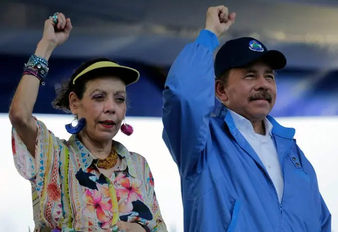 Daniel Ortega speaks at Nicaragua’s Sandinista Revolution anniversary ceremony alongside Rosario Murillo and government officials in Managua.
