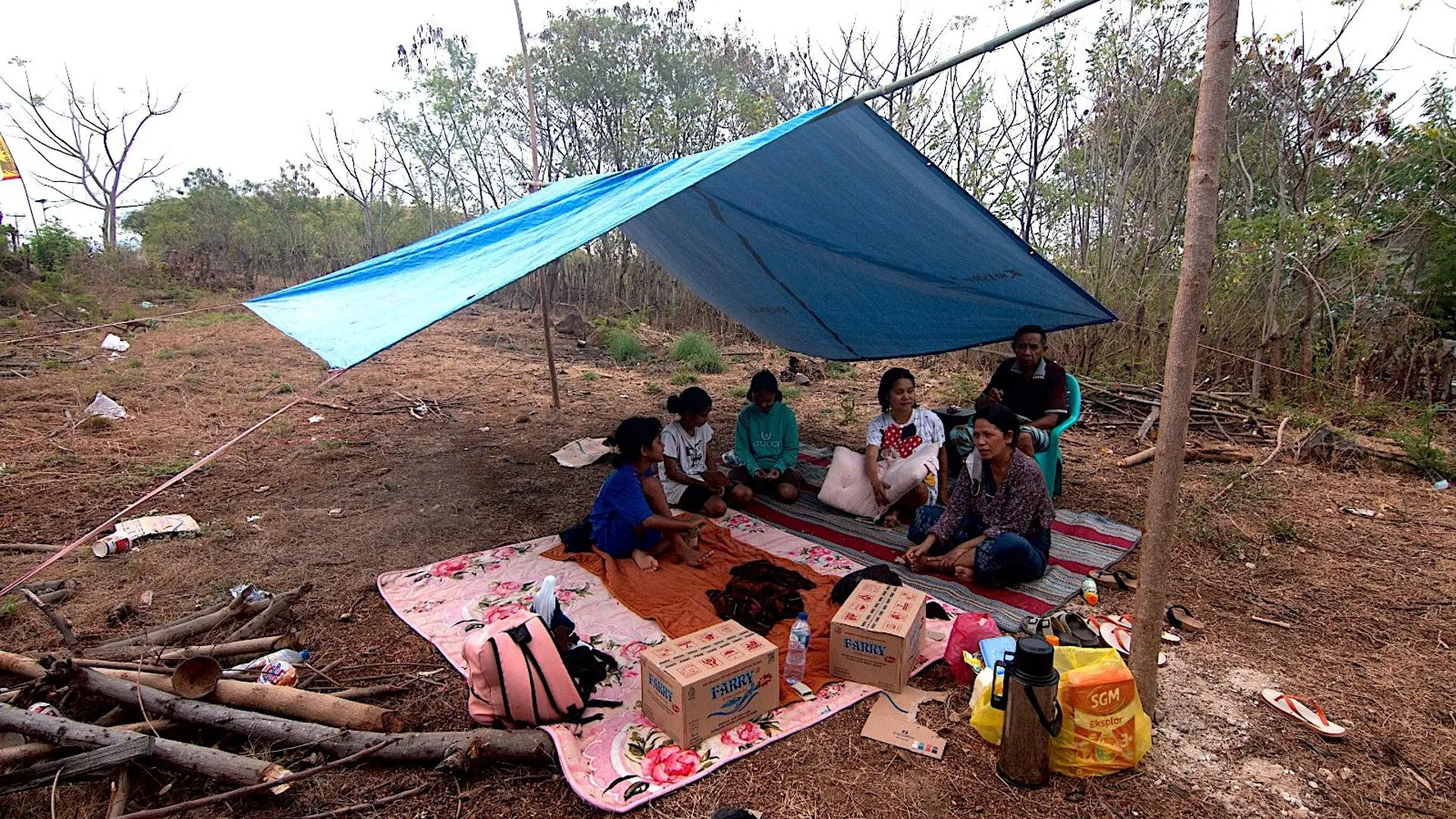 Displaced residents at evacuation centers on Flores island after a deadly 7.7-magnitude earthquake in Indonesia