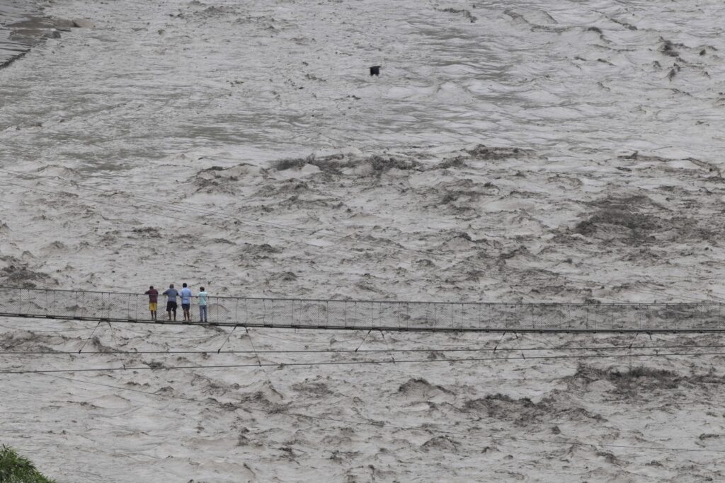 Rescue teams working amid flooding, landslides and heavy rain in Nepal after a deadly flood disaster.