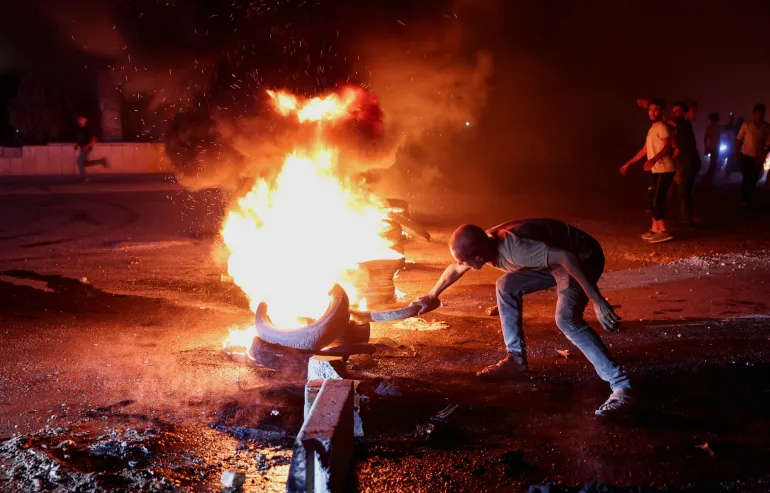 Demonstrators burn tyres during protests over fuel price increases in Syria.