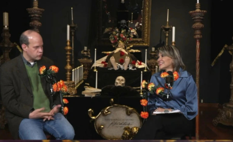 Traditional Mexican altar showing the Day of the Dead origins through marigolds, candles, sugar skulls, and family offerings.